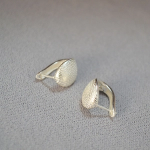 Minimalist matte silver vintage earrings with brushed texture and curved stud design