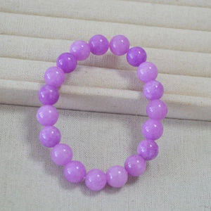 Macro shot of 10mm lavender apatite gemstone beads on an elastic handmade bracelet