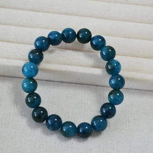 Macro shot of 10mm Kunzite Apatite beaded bracelet showing deep blue natural stone texture