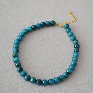 Detail of blue apatite beads with golden adjustable lobster clasp and extension chain