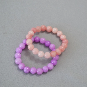 Detailed view of 10mm kunzite and apatite crystal beads with a soft translucent glow