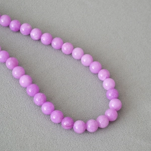 Macro shot of smooth lavender apatite beads on a vintage minimalist collar necklace