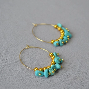 Bohemian gold hoop earrings with irregular turquoise beads and metallic accents