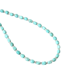 Faceted turquoise beaded necklace with silver metal spacers and natural texture detail