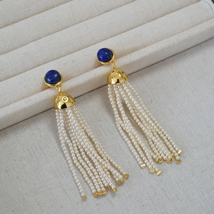 Detailed shot of vintage lapis lazuli earrings with elegant white seed pearl tassels