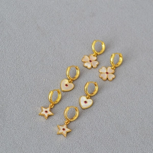 Detailed set of gold plated earrings featuring white clover, star and heart pendants