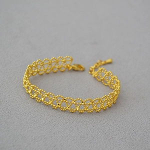 Detail of French vintage gold hollow lace bracelet with lobster clasp and extension chain