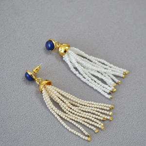 Detailed view of bohemian tassel earrings with lapis beads and white seed bead strands