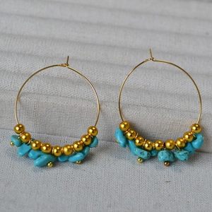 Golden hoop earrings with irregular turquoise stone beads and metallic accents
