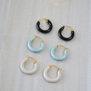 Three pairs of retro acrylic hoop earrings in black, blue, and white marble textures