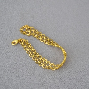 Detail of French vintage gold hollow lace bracelet with lobster clasp and extension chain