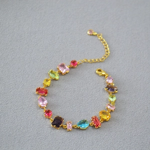 Colorful geometric gemstone bracelet with gold chain and multi-shaped crystal charms