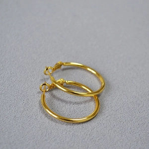 Minimalist oversized gold hoop C-shaped earrings with polished metallic finish