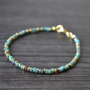 Detail of Miyuki Picasso beaded bracelet with turquoise stones and gold flat spacers