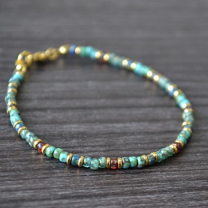 Detail of Miyuki Picasso beads bracelet with turquoise beads and gold metal spacers