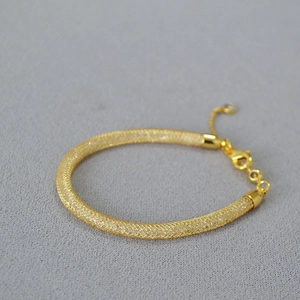 Golden mesh tube necklace filled with sparkling crystals and adjustable lobster clasp closure