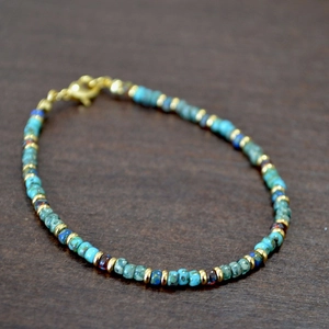 Detail of bohemian Miyuki bead bracelet with turquoise stones and gold metal spacers