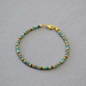 Detail of Miyuki Picasso beaded bracelet with turquoise and gold spacer rings and clasp