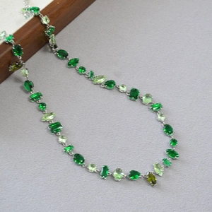 Silver necklace with mixed multi-shape green gemstones in emerald and olive hues