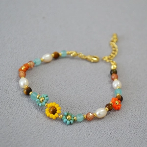 Handmade beaded flower bracelet with natural pearls and sunflower motif in oil painting style