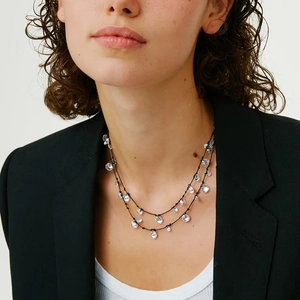 Collana a doppio strato in cordino nero con pendenti a fiore in cristallo lucido su modella