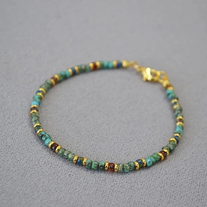 Detail of Miyuki Picasso beads bracelet with turquoise tones and golden lobster clasp