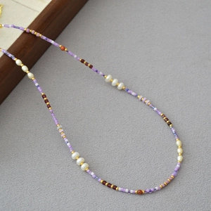 Handmade violet and white seed bead necklace with pearls and golden accents for summer style