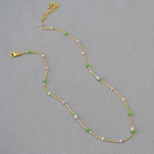 Golden chain necklace with colorful round disc beads in green, pink and beige tones