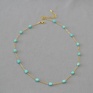 Detail of beaded gold chain with faceted turquoise stones and adjustable lobster clasp