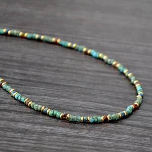 Macro shot of bohemian seed bead necklace with blue, gold and brown beads detail