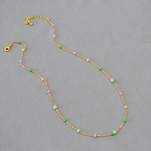 Golden delicate chain necklace featuring colorful square beads and an adjustable lobster clasp