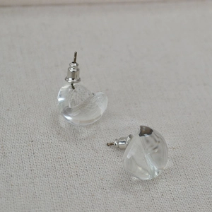 Minimalist summer clear glass water drop stud earrings on textured linen background
