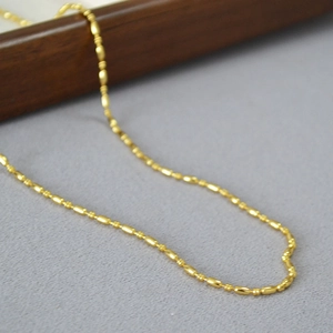 Elegant minimalist brass gold plated thin necklace featuring small oval beads and links