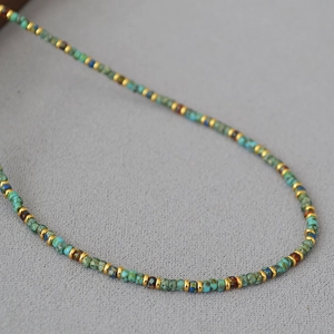 Macro shot of bohemian handmade Miyuki beads with antique texture and gold spacers