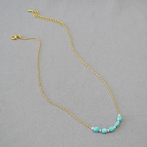 Minimalist gold chain necklace with faceted turquoise beads and adjustable lobster clasp