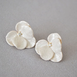 Elegant white enamel orchid flower stud earrings with a central sparkling zircon stone