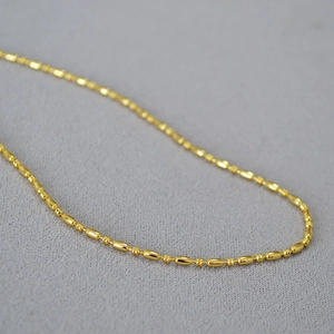 Detailed close-up of brass gold plated bamboo link chain showing shiny metallic texture