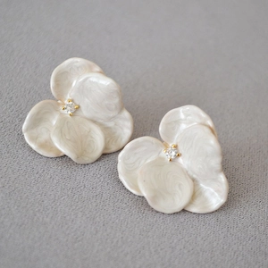 Elegant white enamel orchid flower earrings with center crystals and gold finish