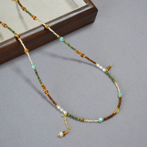 Collier artisanal de style bohème avec perles colorées et détails dorés fins