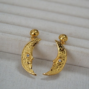 Detailed view of moon-face earrings in vintage gold plating with sparkling cubic zirconia