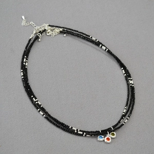 Three-layer black beaded choker necklace with vibrant round colorful gemstone pendants