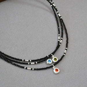 Three-layer black beaded necklace with colorful zircon pendants in blue green and red