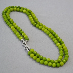 Detailed view of dual-layer light green jade bead necklace with silver diamond buckle