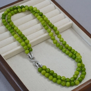 Double-layered olive green jade bead necklace with a silver diamond infinity clasp