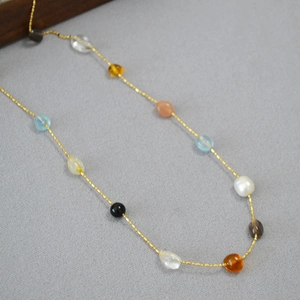 Minimalist gold chain necklace featuring colorful irregular crystal beads and pearls