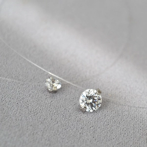 Vue macro d'un collier en fil de nylon invisible avec deux zircons brillants