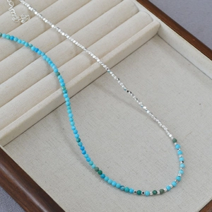Handmade necklace with silver square beads and blue turquoise stones in a jewelry box
