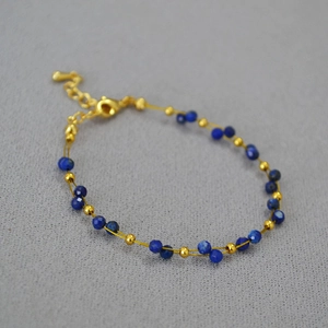 Detail of double-layer lapis lazuli beaded bracelet with gold thread and lobster clasp