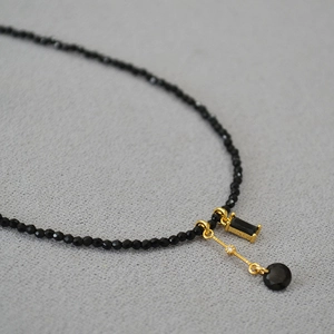 Collier minimaliste en spinelle noire avec pendentif géométrique en or et pierre noire