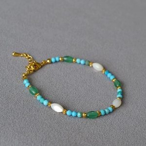Minimalist turquoise and pearl bead bracelet with gold accents and lobster clasp